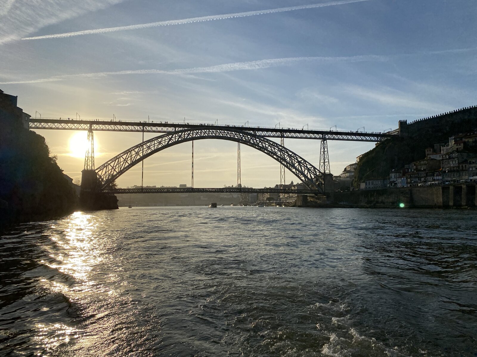 A Port Sailors sailboat on the Douro by the Ribeira with the Dom Luís I bridge behind